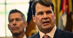 Ford cancels the F-150 Lightning EV. On December 3, 2025, US President Donald Trump makes an announcement from the White House's Oval Office in Washington, DC, while Ford CEO Jim Farley speaks. As part of his plan to reduce the cost of gasoline-powered vehicles, President Trump announced looser fuel efficiency regulations for the nation. (Photo by ANDREW CABALLERO-REYNOLDS / AFP via Getty Images)